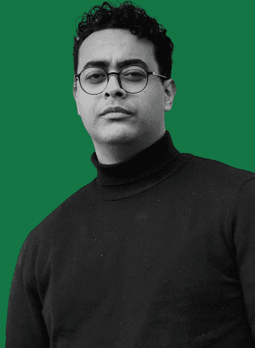 Portrait of Youssef Amir wearing glasses and a dark turtleneck
